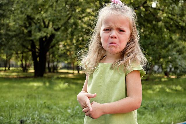 Upset girl child crying in the park