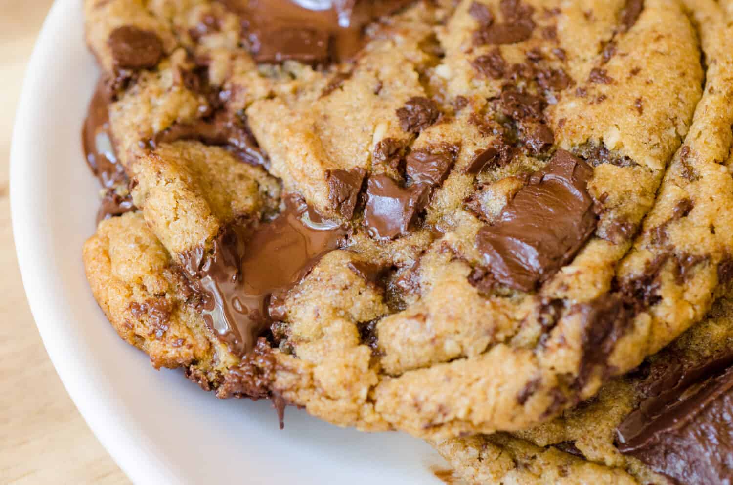 A classic photo of melt in your mouth ooey, gooey perfect chocolate chip cookies made with a mix of flours, browned butter, bittersweet chocolate and sea salt.