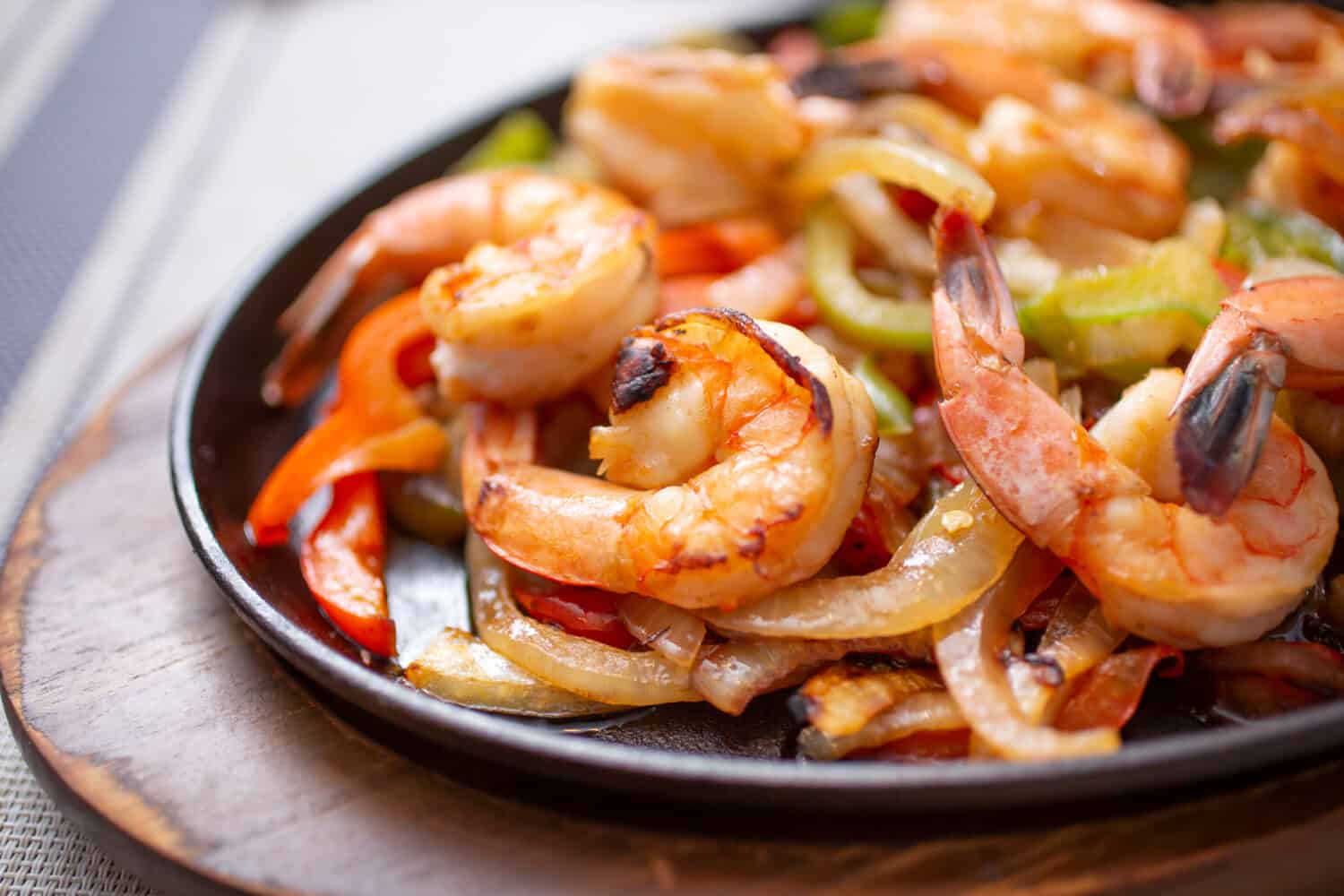 A view of a skillet of shrimp fajitas.