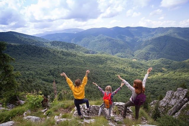 girls standing at the edge of rock