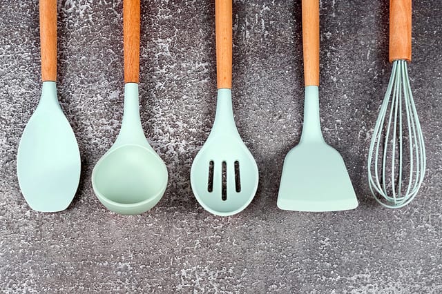 Kitchen utensils, home kitchen tools, mint rubber accessories on dark background. Restaurant, cooking, culinary, kitchen theme. Silicone spatulas and brushes, free copyspace for text