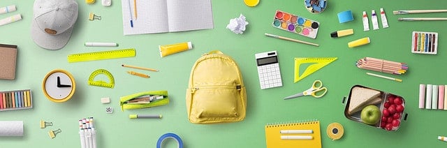 Flat lay top view of face mask and school supplies, back to school and coronavirus concept.