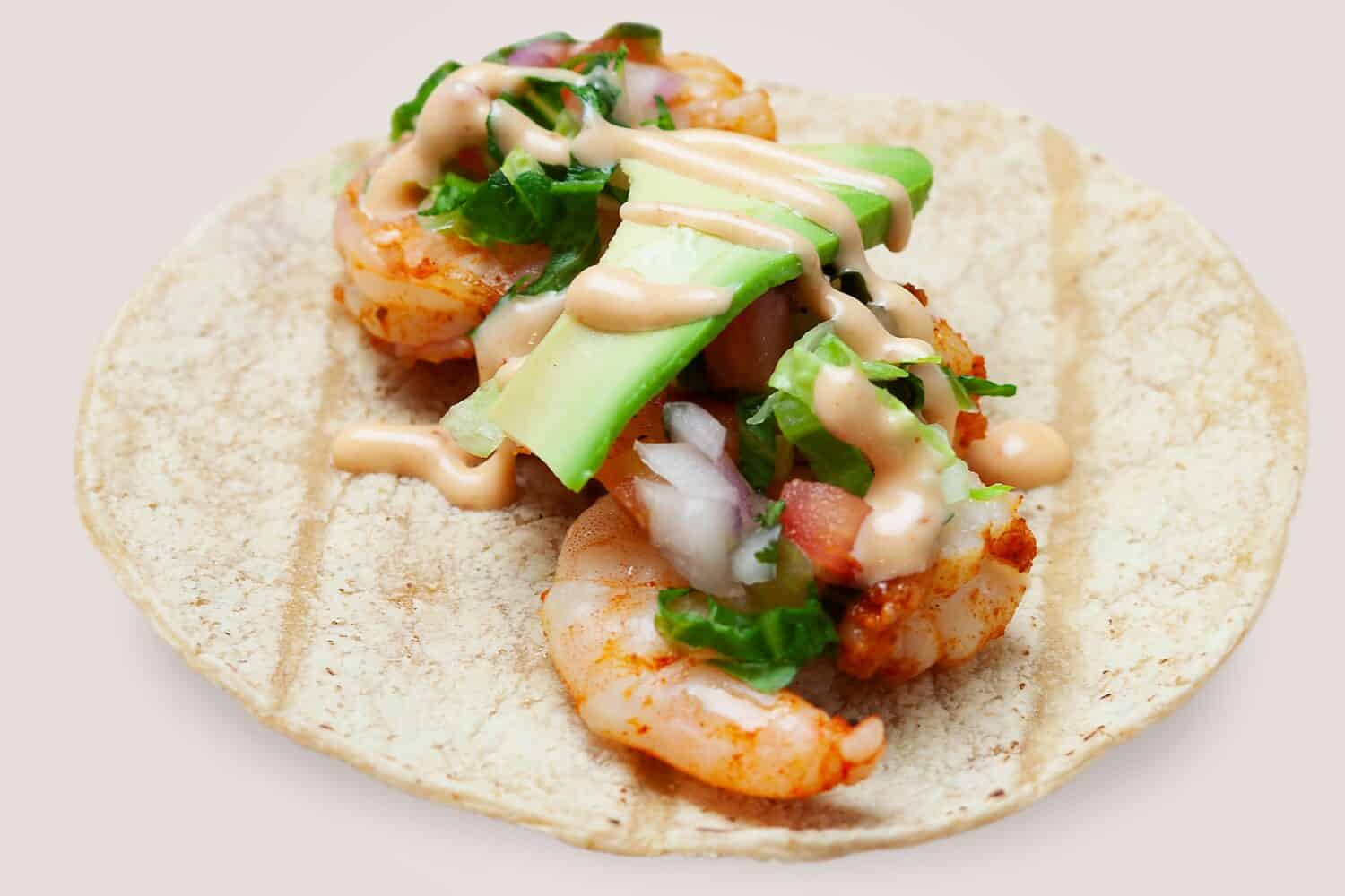 Shrimps tacos, vegetables, avocado. with Pineapple Chipotle Sauce, Mexican food.