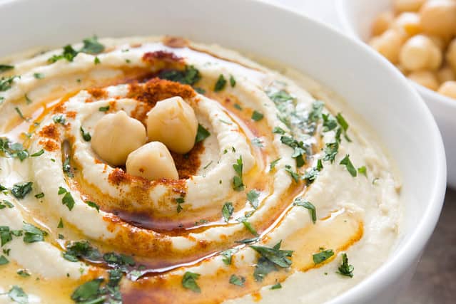 Hummus on a rustic wooden table