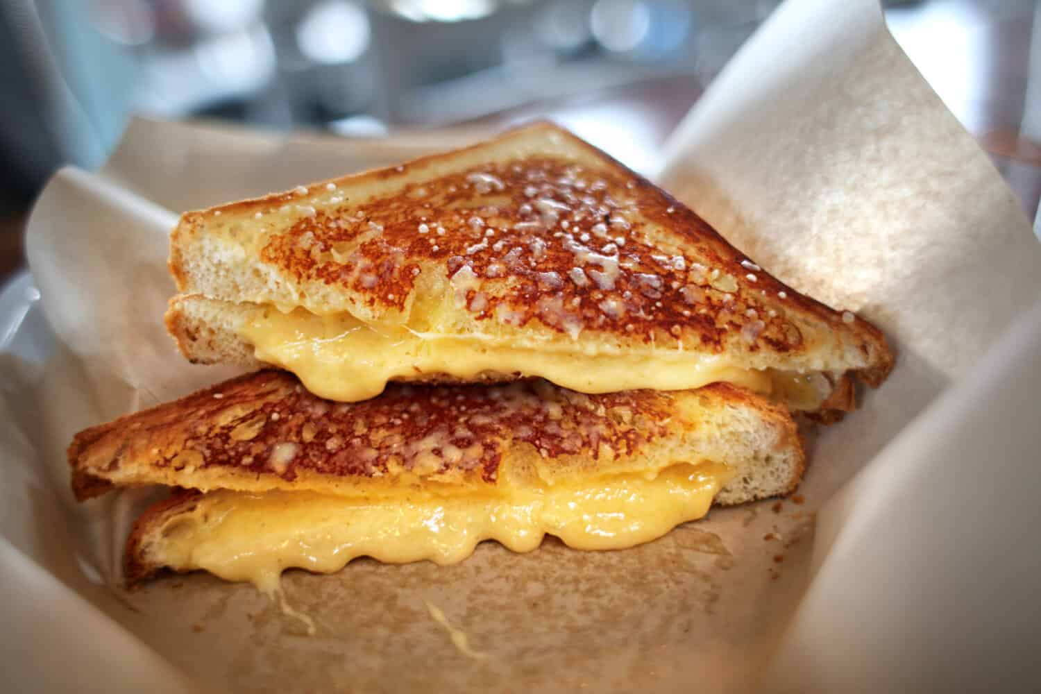 Grilled cheese sandwich gourmet four cheese in basket cut in half melted