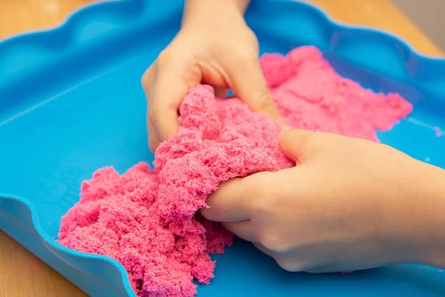 Child playing with Kinetic Sand