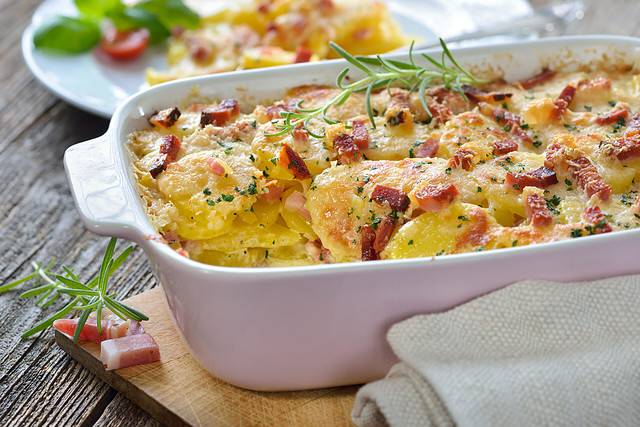 Potato gratin with parmesan cheese, cream and delicious cured bacon